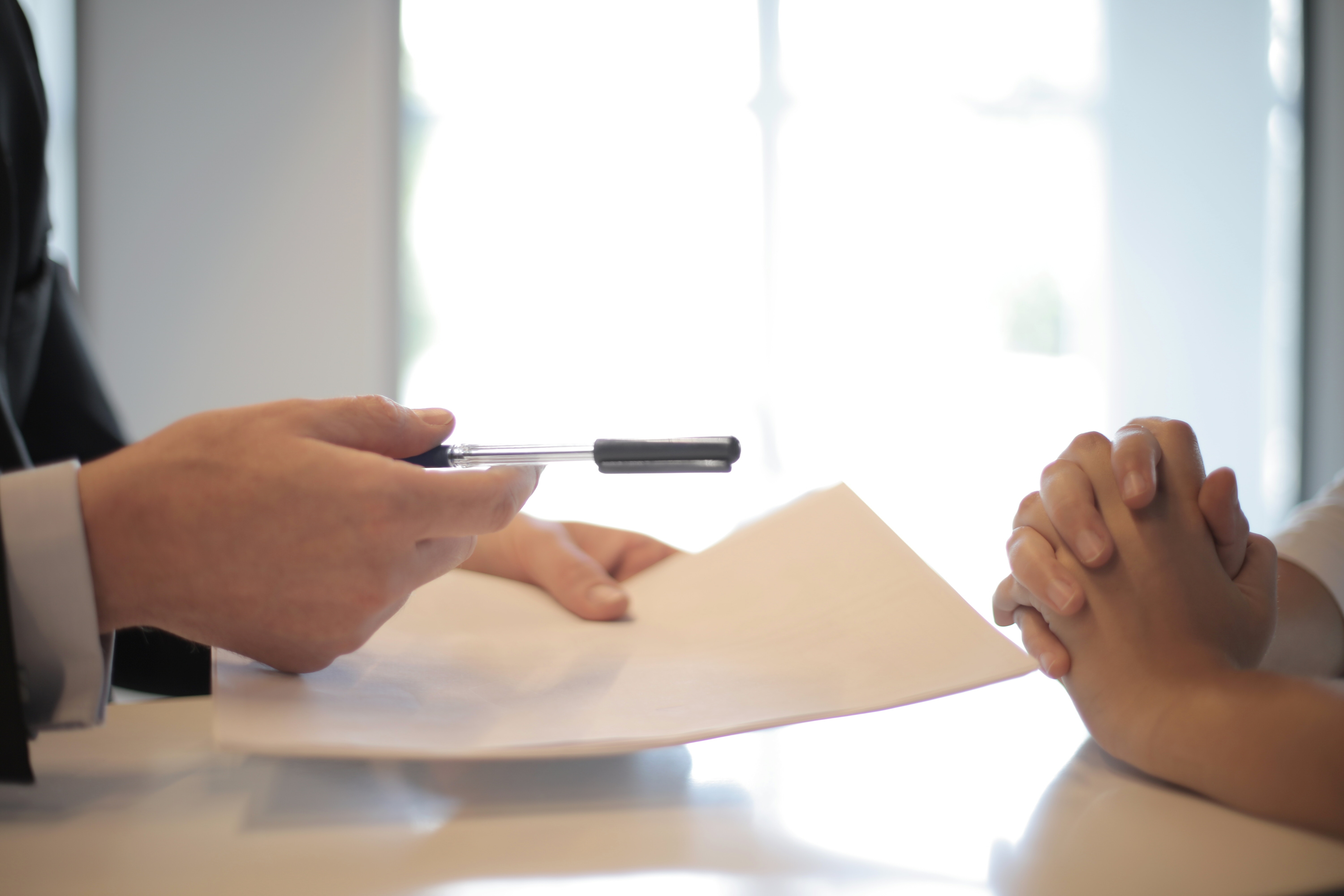 un homme tend un contrat à signer à un candidat